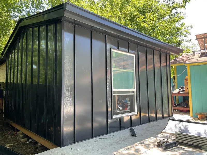 Black standing seam metal wall panels for Roof Inspection in Pacifica